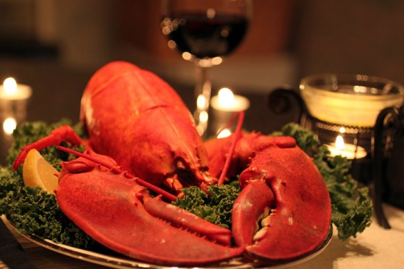 A big red cooked lobster on a garnished plate, a welcome sight! Gourmet Secrets can make it happen!